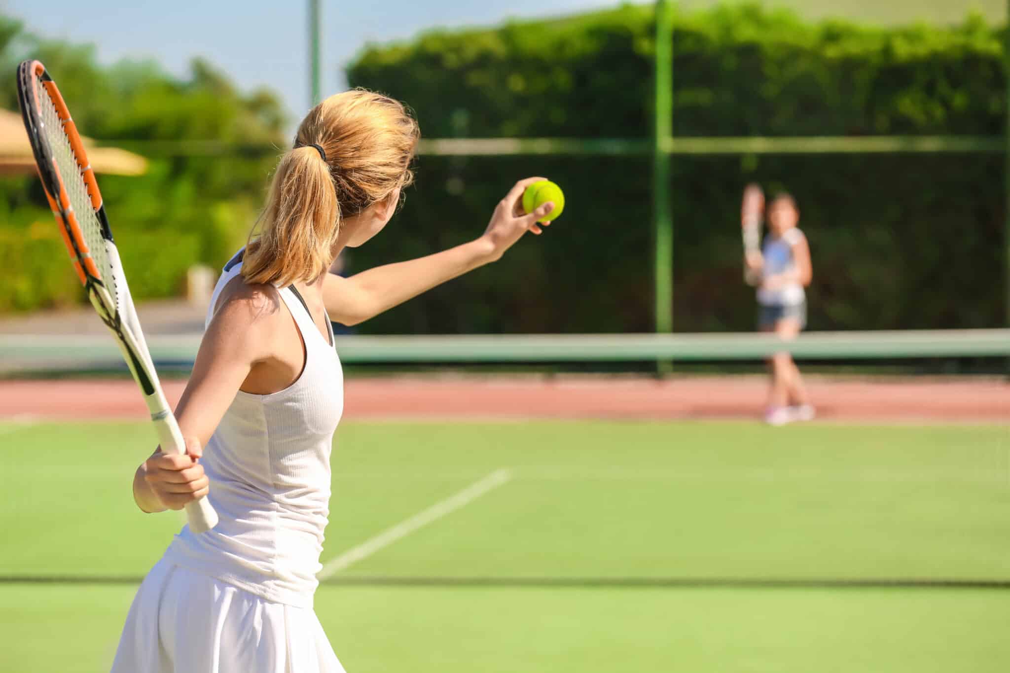 Woman serving during a tennis match