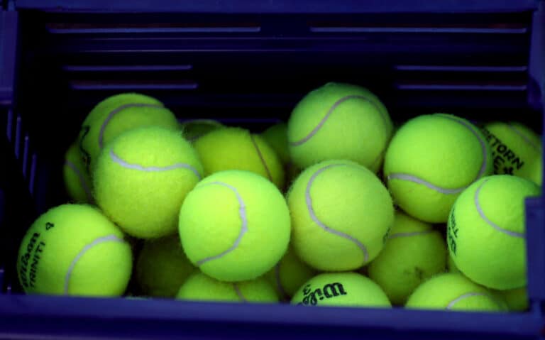 Close Up View Of Tennis Balls In Container