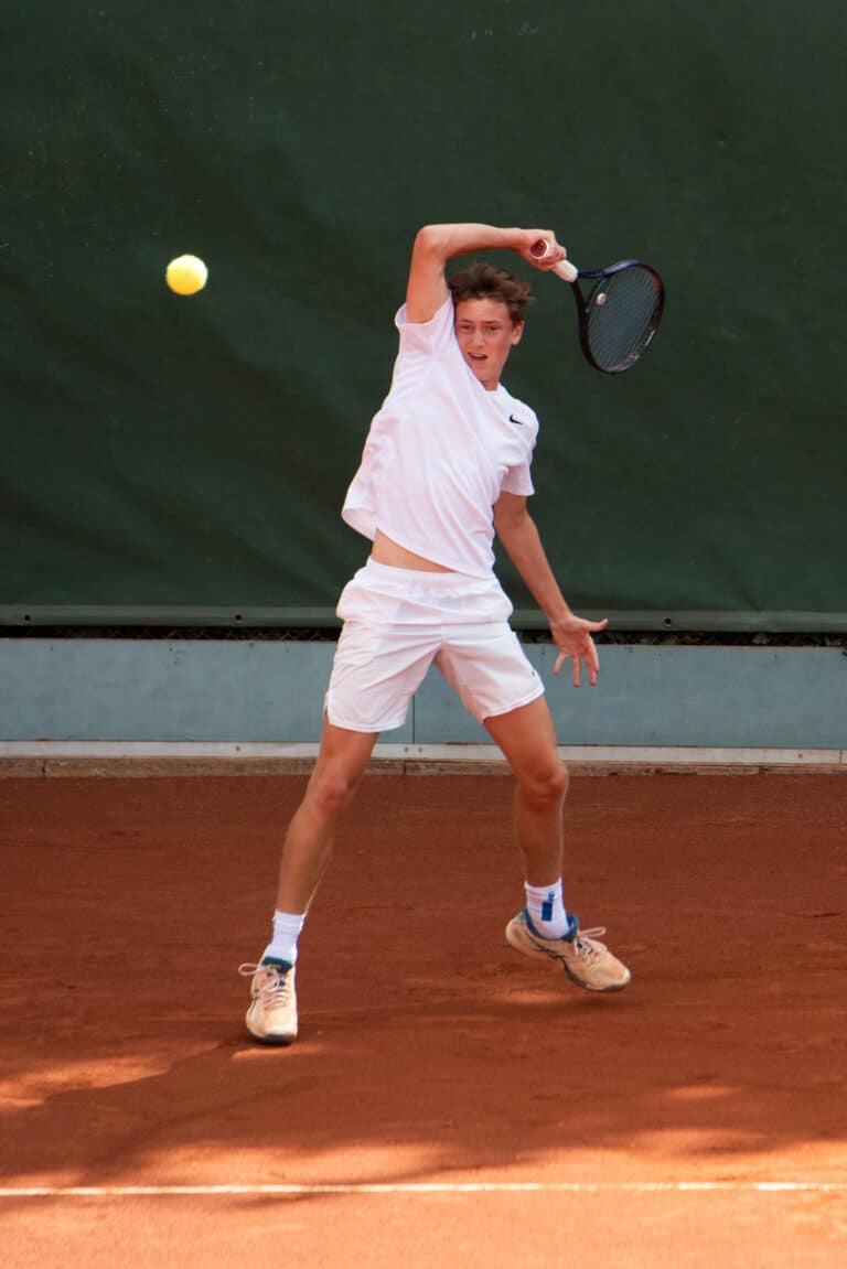 View of tennis player swinging tennis racket