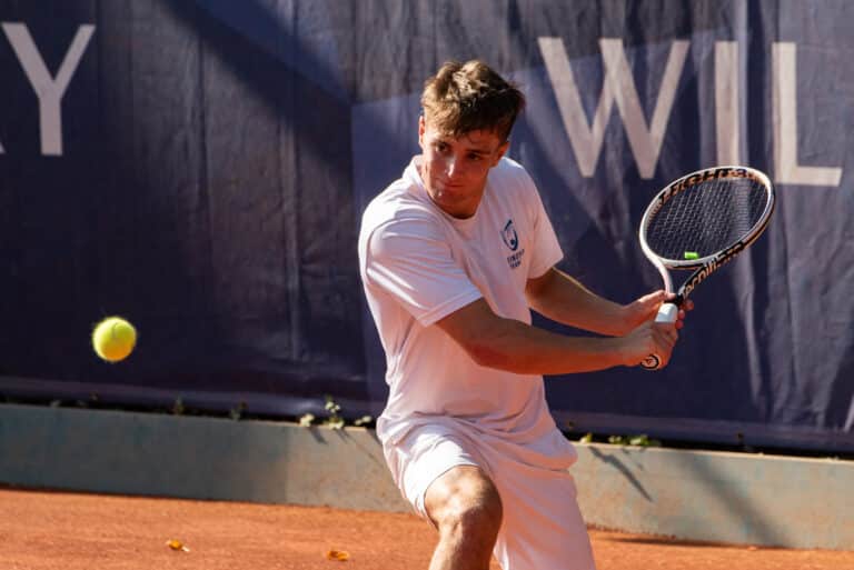 Portrait view of tennis player swinging tennis racket
