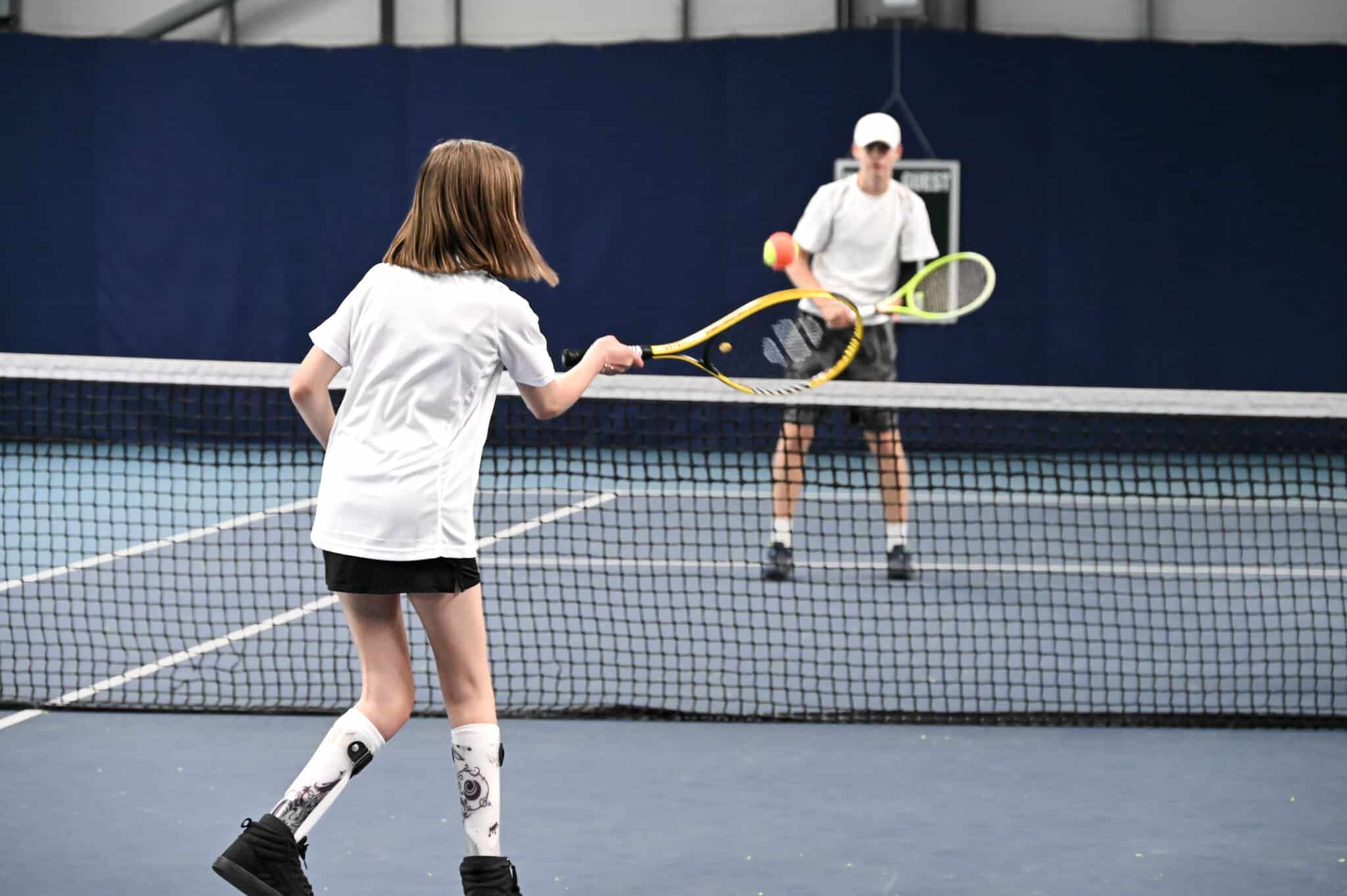 Para standing tennis player at the net